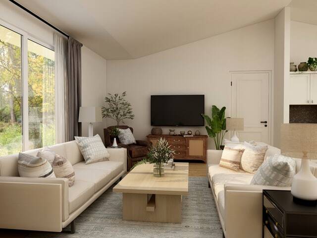 a living room with two cream colored couches and beige walls